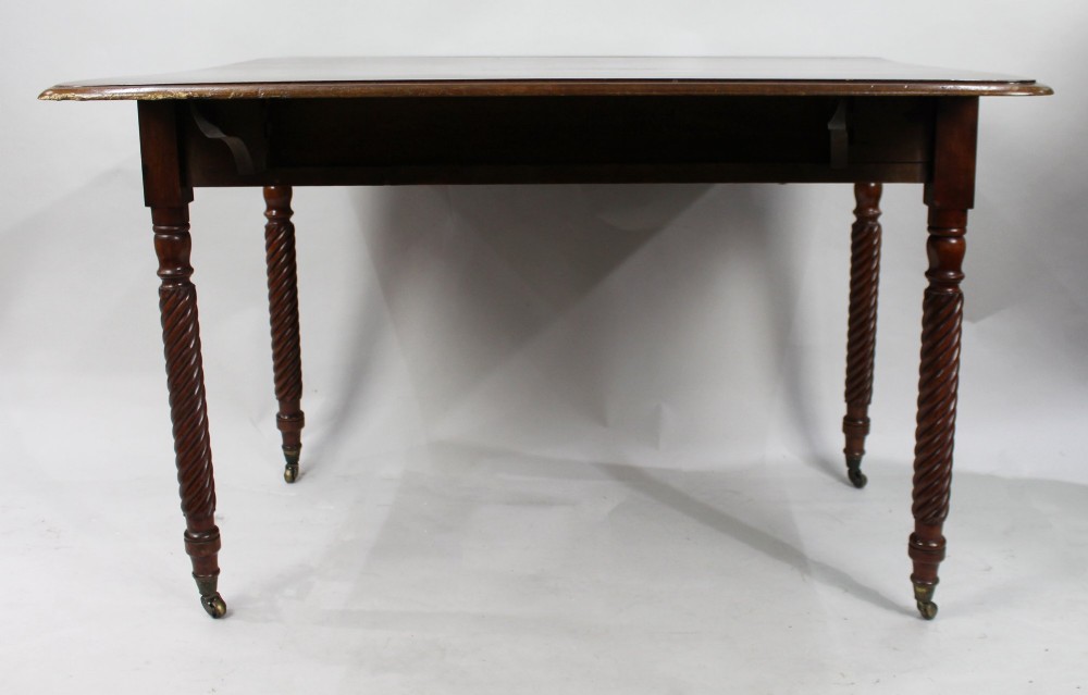 A Victorian mahogany Pembroke table with two hinged drop leaves, a single end drawer with turned wood knobs, spiral-twisted legs, and brass castors. View V