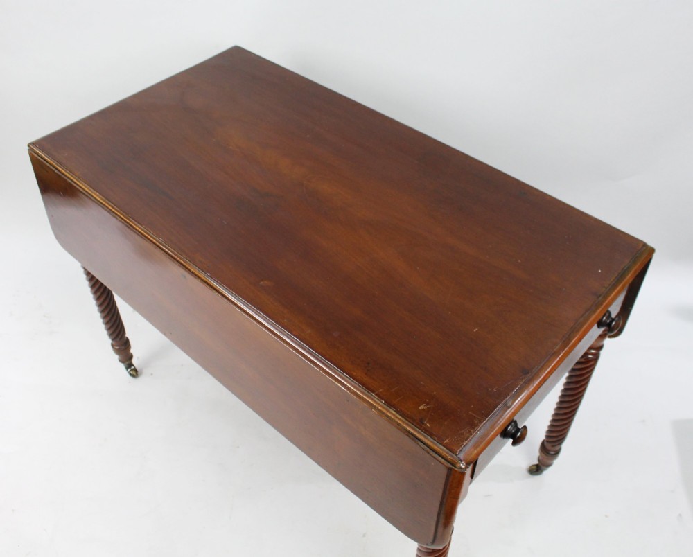 A Victorian mahogany Pembroke table with two hinged drop leaves, a single end drawer with turned wood knobs, spiral-twisted legs, and brass castors. View VII