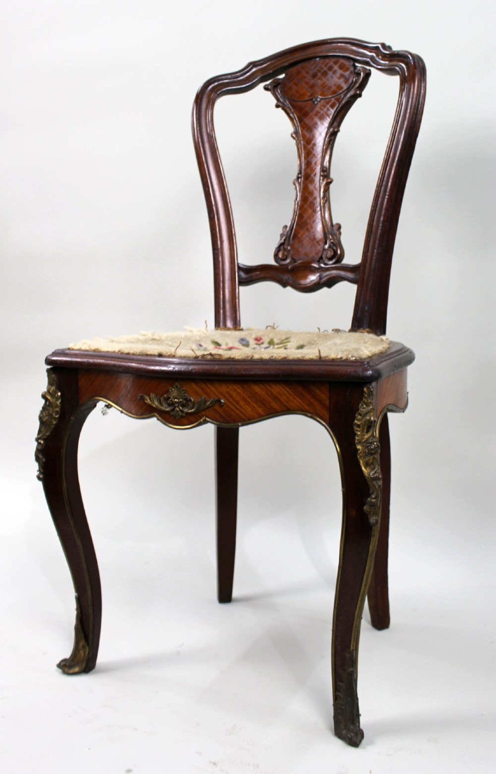 An antique French side chair featuring a kingwood back frame with a parquetry splat, cabriole front legs decorated with ormolu mounts, and a floral needlepoint seat. View II