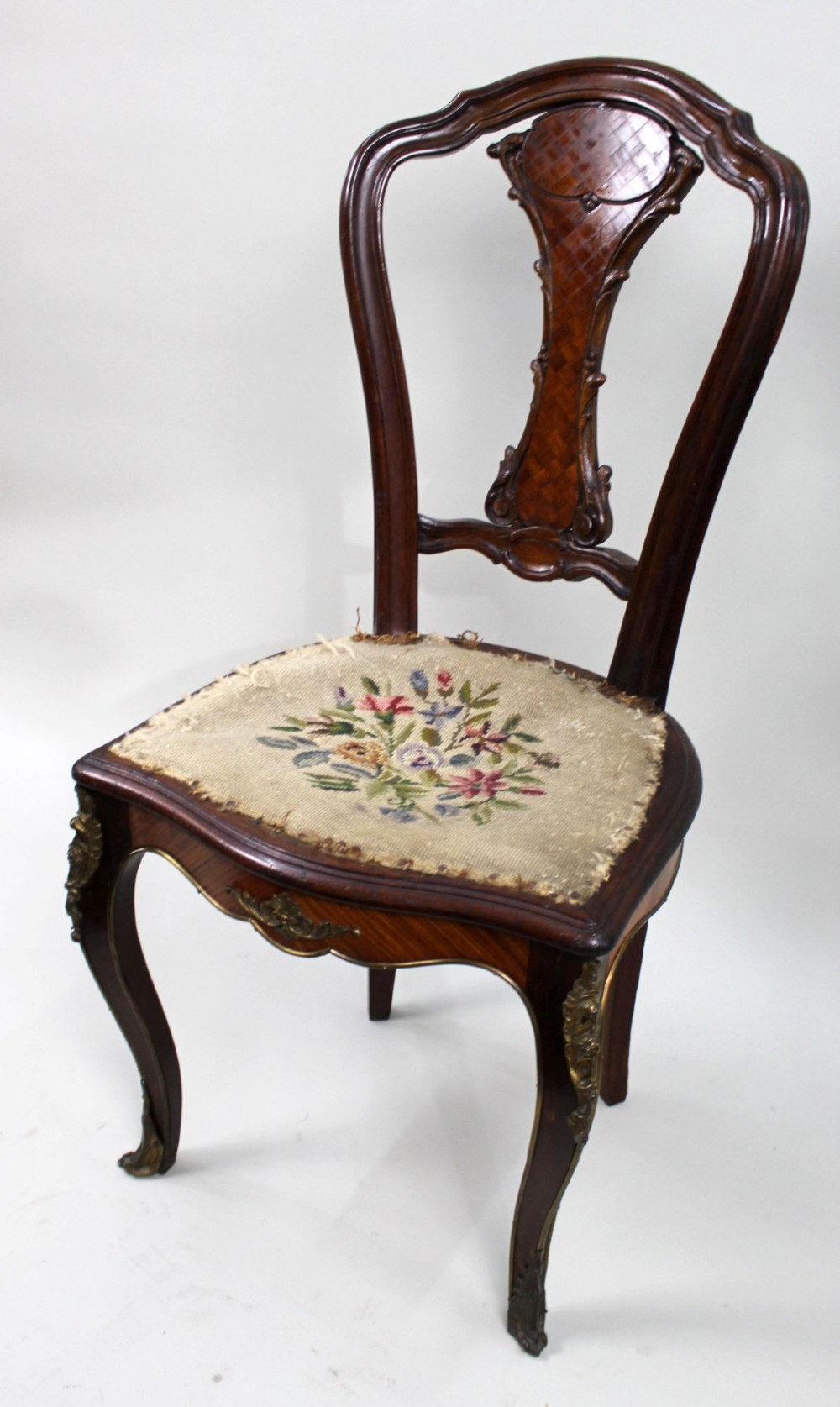 An antique French side chair featuring a kingwood back frame with a parquetry splat, cabriole front legs decorated with ormolu mounts, and a floral needlepoint seat. View III