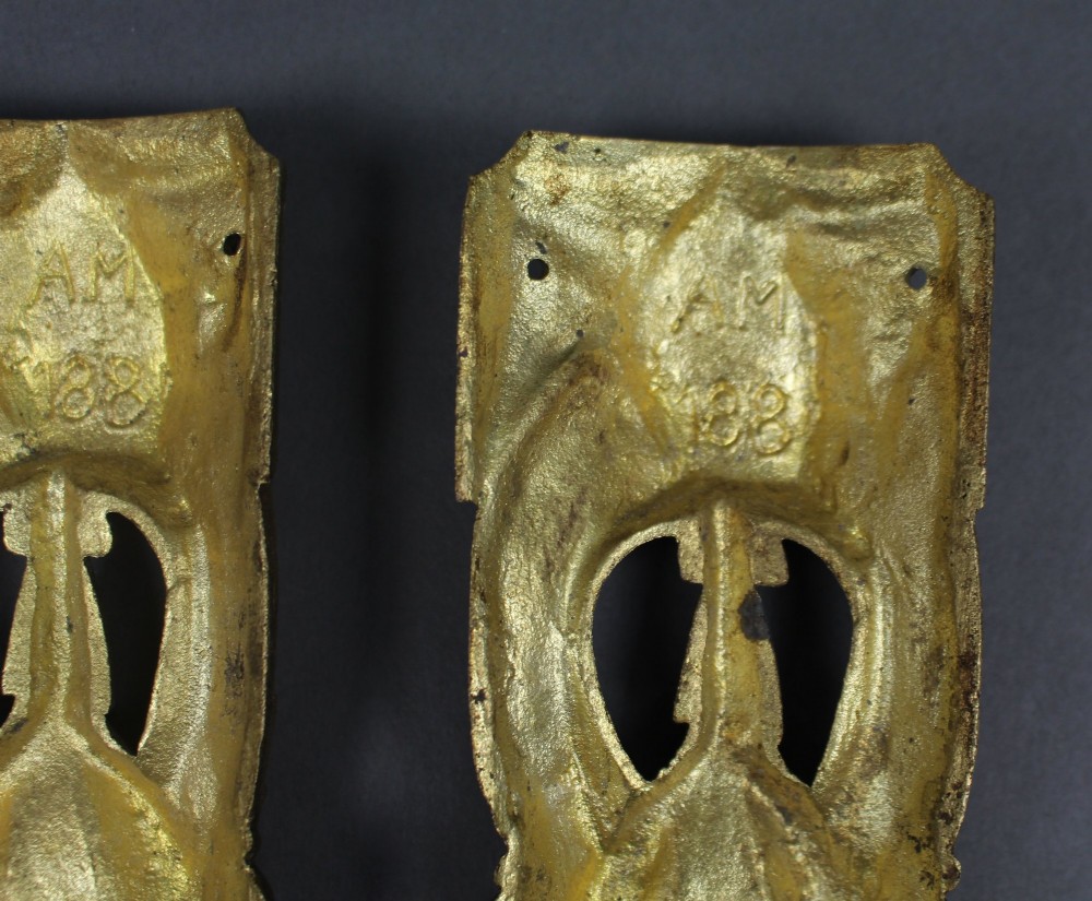 A pair of ornate gilt bronze furniture mounts featuring acanthus leaf scrollwork and symmetrical pierced design in the Louis XVI style. View VIII