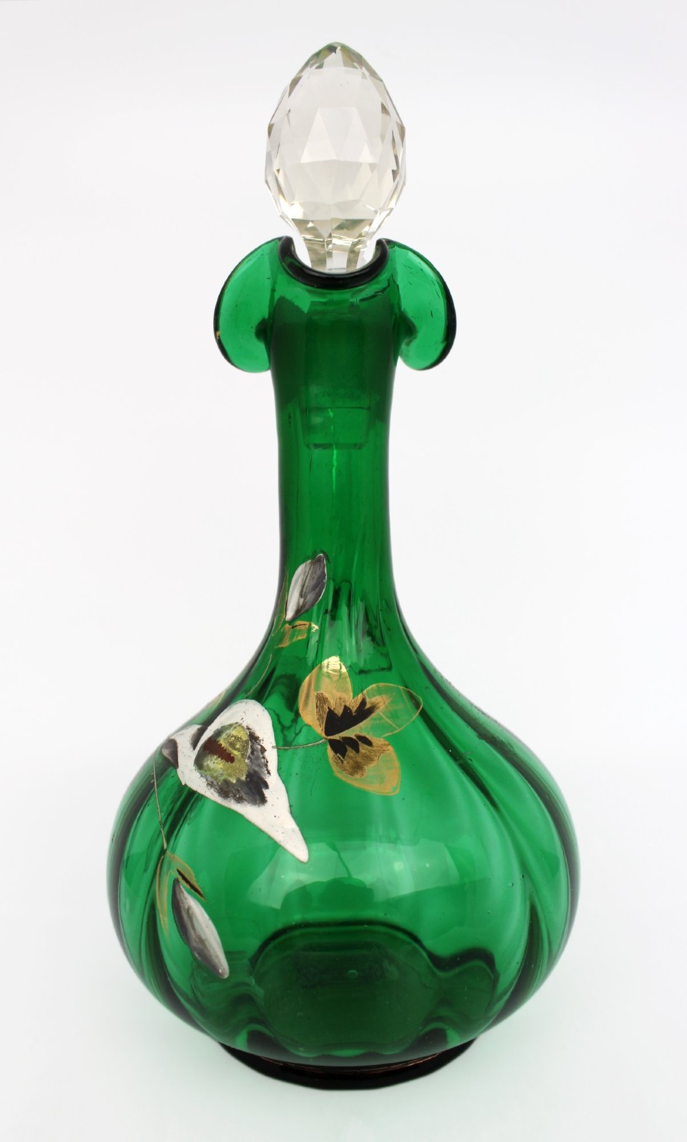 An emerald green glass claret jug featuring a ribbed bulbous body decorated with hand-painted gold floral motifs, a clear looped handle, and a faceted clear glass stopper. View II