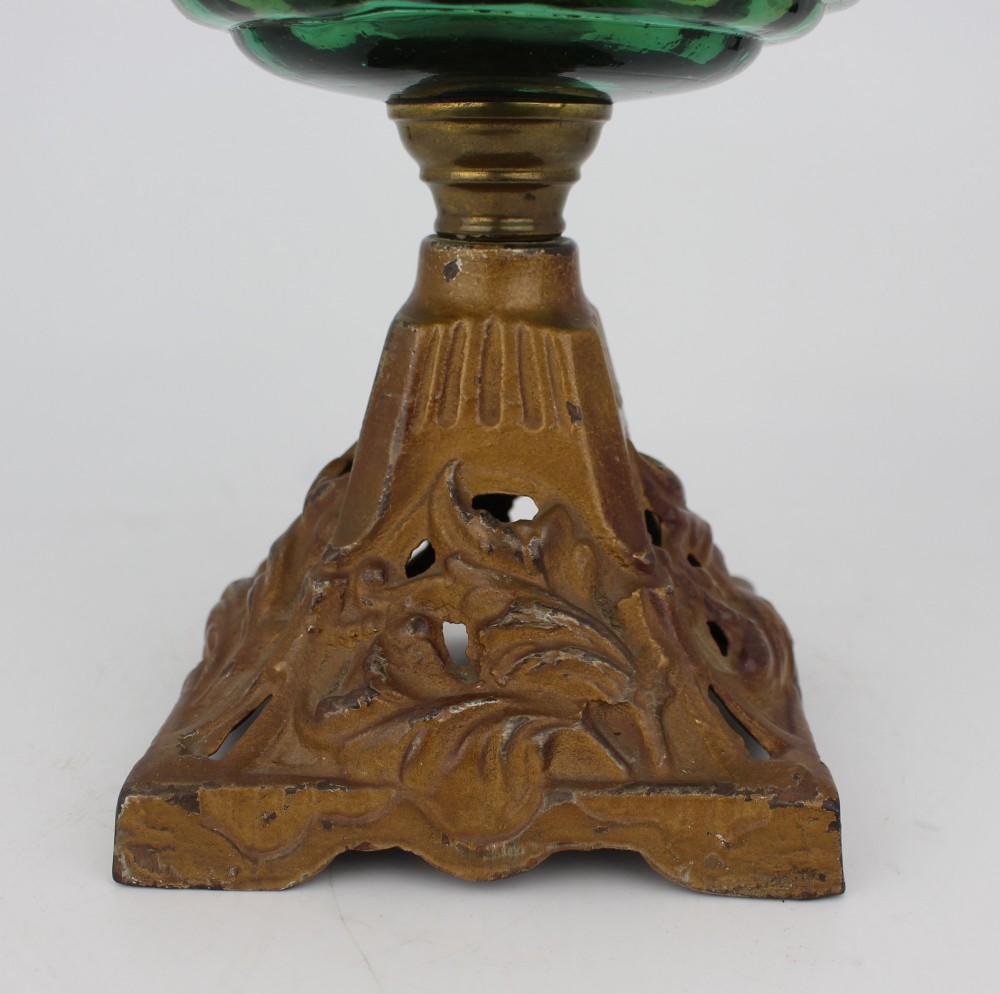 An antique Victorian oil lamp featuring a cast metal base with scrolling leaf motifs, a vibrant blue glass font, and a brass burner gallery. View XIV