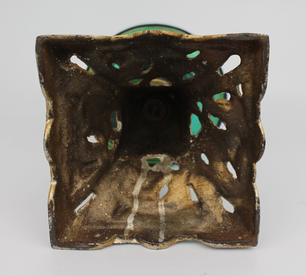 An antique Victorian oil lamp featuring a cast metal base with scrolling leaf motifs, a vibrant blue glass font, and a brass burner gallery. View XV