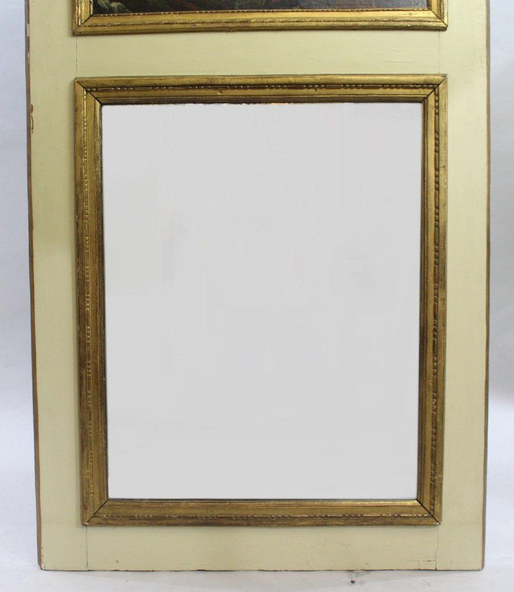 A tall cream-painted French trumeau wall mirror featuring an upper framed pastoral oil painting and a lower rectangular mirror glass set within gilded mouldings. View VI