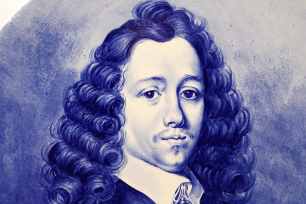 A circular glazed ceramic charger featuring a monochrome cobalt blue hand-painted portrait of a seventeenth-century man against a light blue background. View II