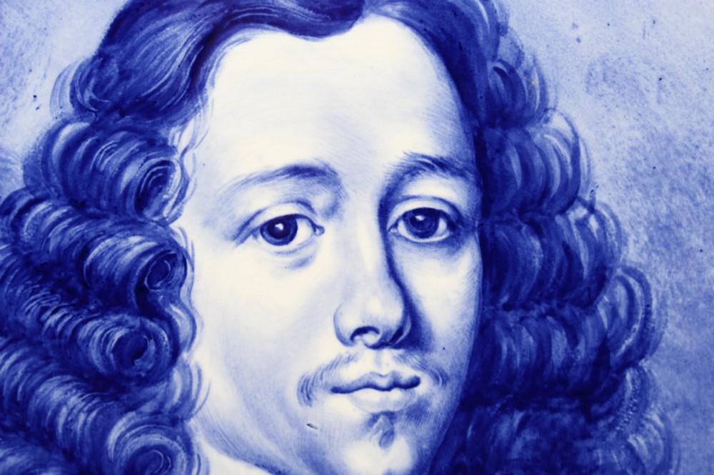 A circular glazed ceramic charger featuring a monochrome cobalt blue hand-painted portrait of a seventeenth-century man against a light blue background. View IV