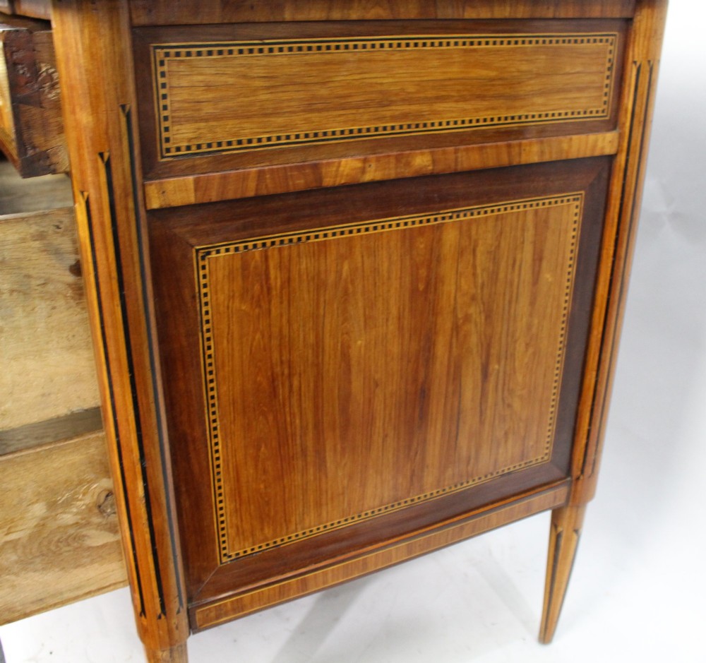 An 18th-century French Louis XVI commode featuring geometric parquetry wood inlay, tapered legs, brass ring handles, and a grey marble top. View XI