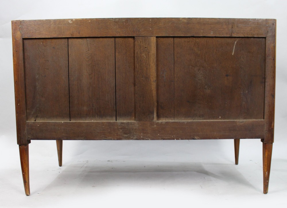 An 18th-century French Louis XVI commode featuring geometric parquetry wood inlay, tapered legs, brass ring handles, and a grey marble top. View XII