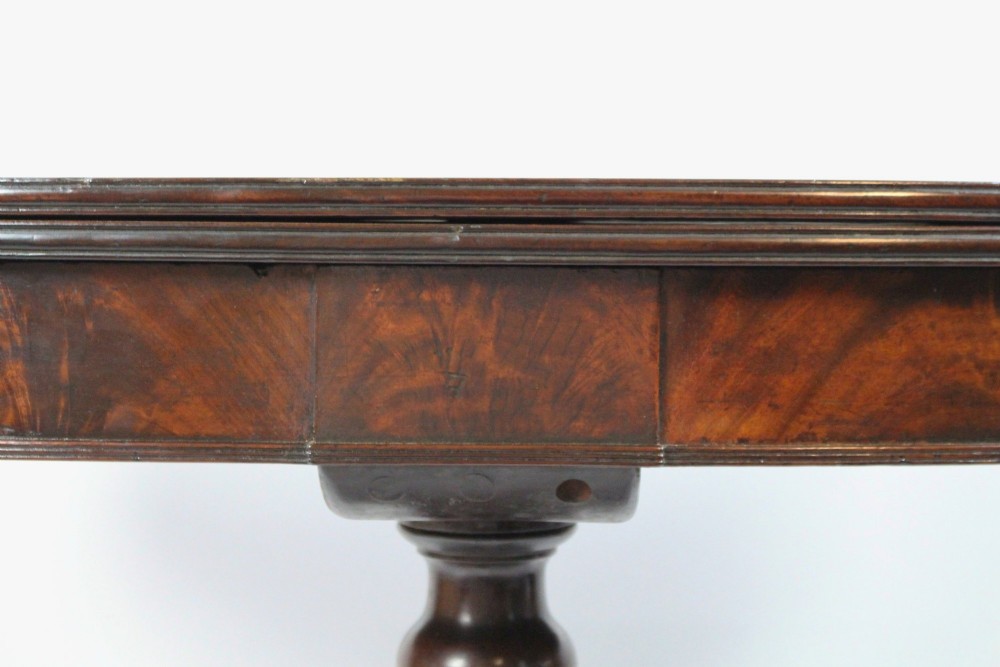 An early nineteenth-century Regency mahogany tea table with a folded rounded top resting on a turned central column and four splayed legs with brass castors. View VIII