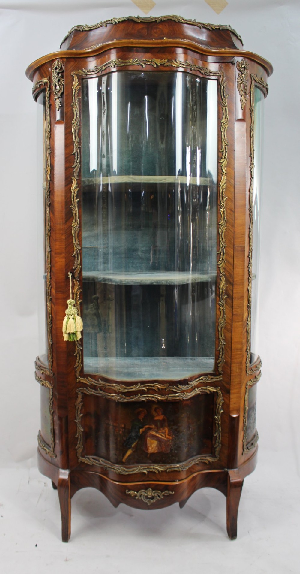 A nineteenth-century French serpentine display cabinet featuring curved glass panels, gilt bronze mounts, and hand-painted Vernis Martin panels on the lower section.