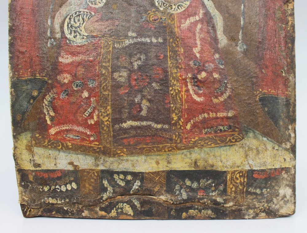 An 18th-century Andean colonial oil painting on canvas depicting the Madonna and Child clad in decorative red and gold patterned garments with a lace veil. View II