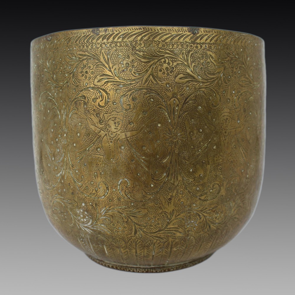 A rounded antique brass cachepot featuring densely hand-engraved floral foliage, figural motifs, and stippled background detailing.