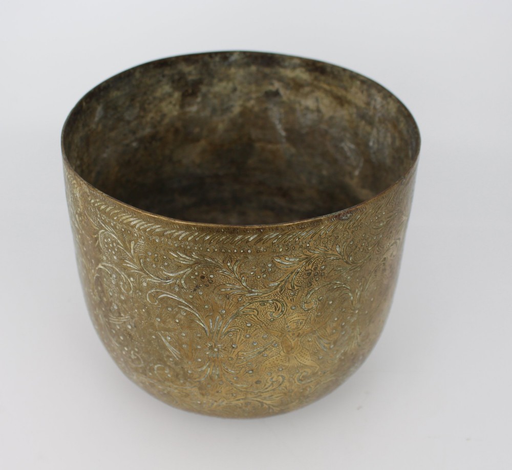 A rounded antique brass cachepot featuring densely hand-engraved floral foliage, figural motifs, and stippled background detailing. View V