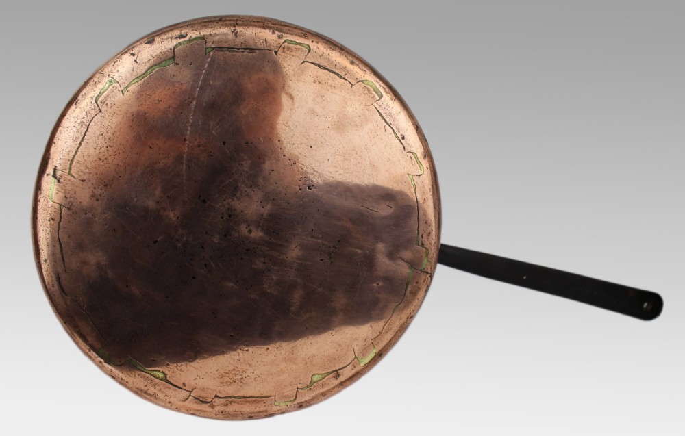 A large antique Georgian copper saucepan featuring a straight cylindrical body and a long wrought iron handle fastened with metal rivets. View XI