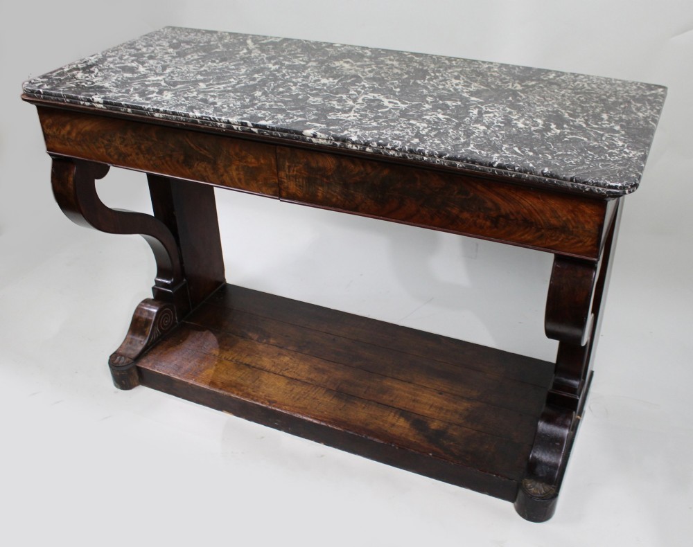An antique dark mahogany French console table featuring a grey and white mottled marble top, curved scroll legs, and a low plinth shelf. View II