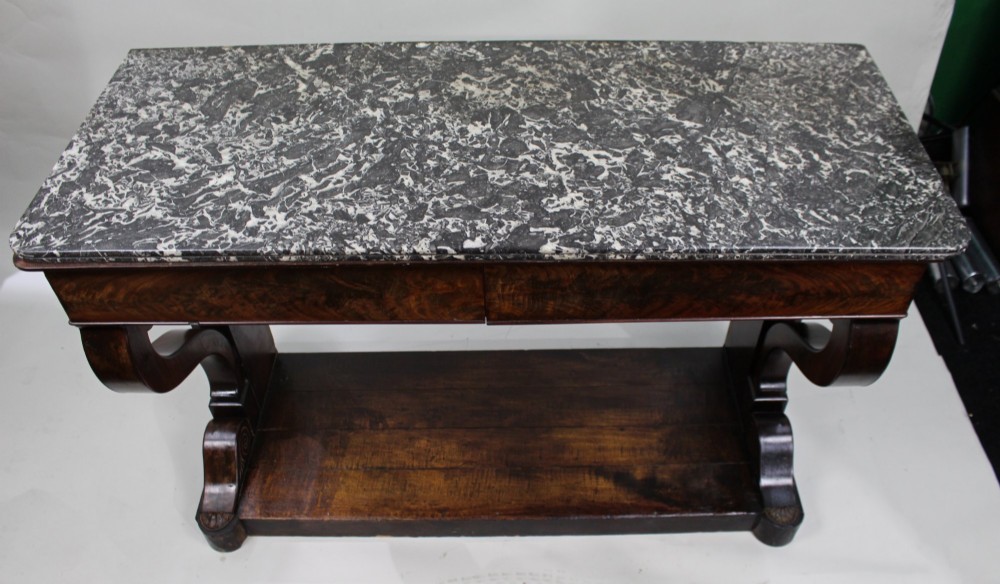An antique dark mahogany French console table featuring a grey and white mottled marble top, curved scroll legs, and a low plinth shelf. View V