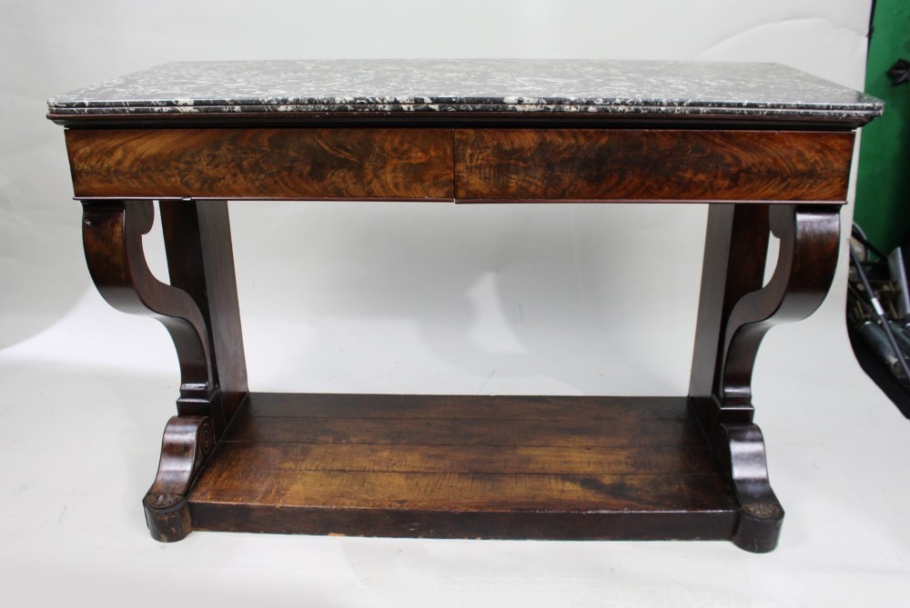 An antique dark mahogany French console table featuring a grey and white mottled marble top, curved scroll legs, and a low plinth shelf. View VI