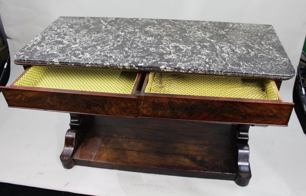 An antique dark mahogany French console table featuring a grey and white mottled marble top, curved scroll legs, and a low plinth shelf. View IX