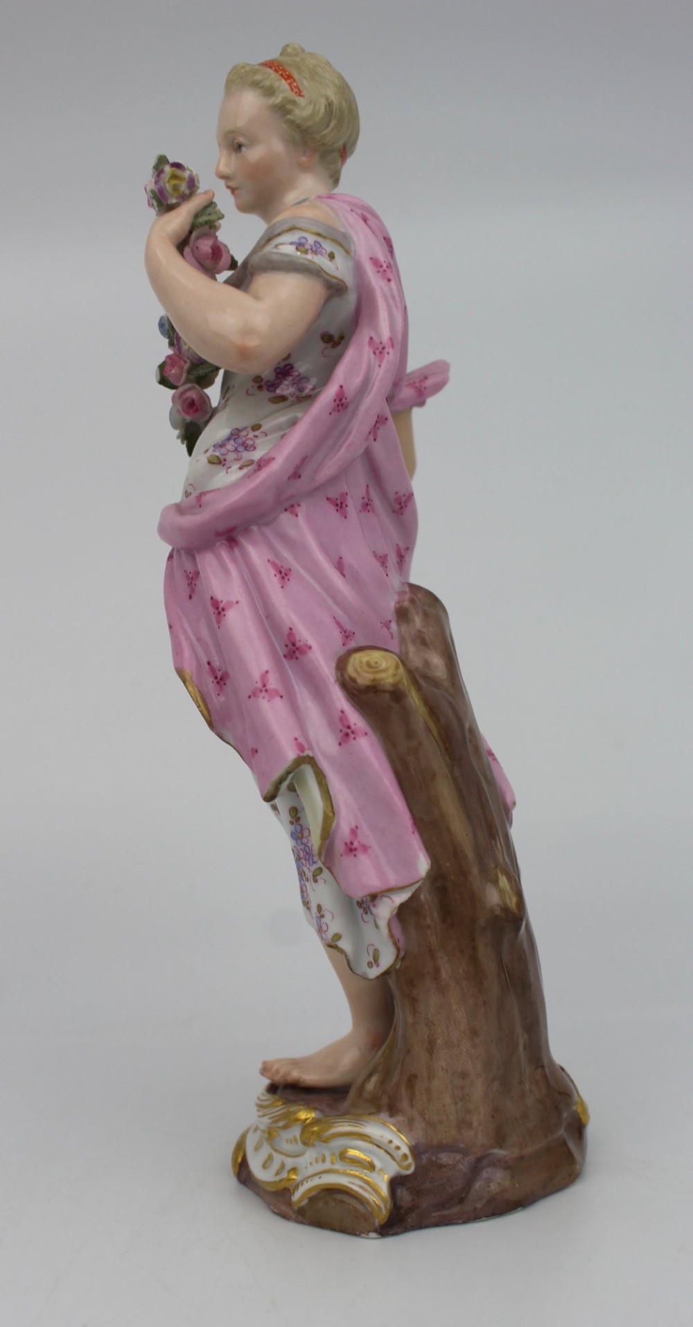 A set of four 19th-century hand-painted porcelain figurines representing the seasons standing on gilded scroll bases. View V