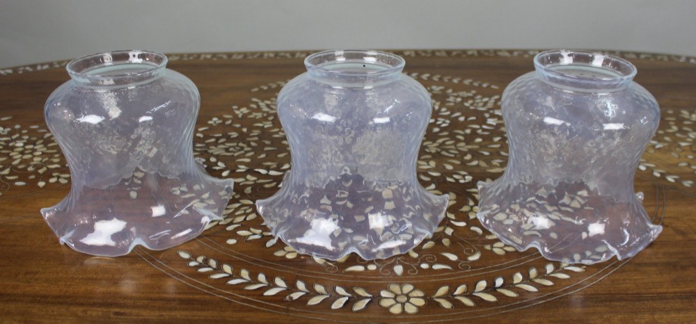 An antique Gothic Revival brass three-light gasolier frame with pierced strapwork alongside three ruffled opalescent glass shades. View XII