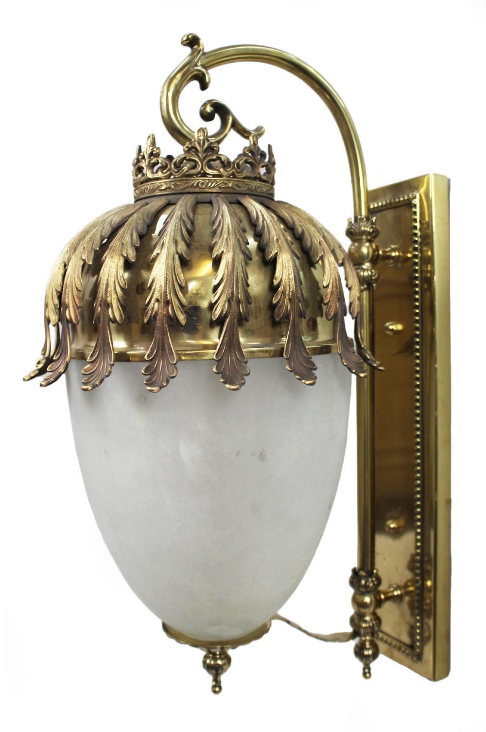 An antique brass wall lantern featuring a frosted ovoid glass shade draped with cast acanthus leaves and topped with a decorative cresting collar. View VII