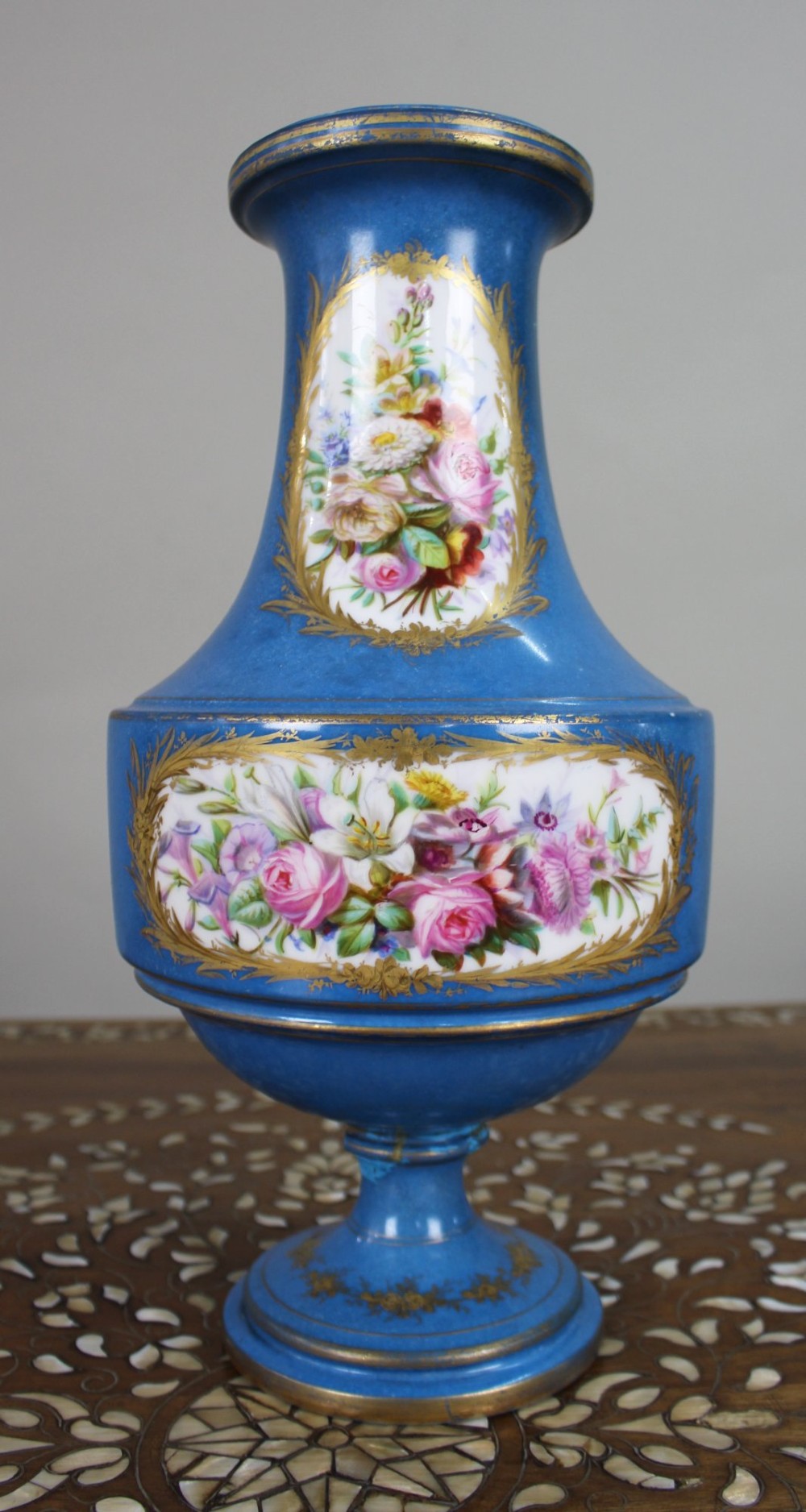 A late 19th-century Sevres-style turquoise porcelain vase featuring hand-painted portrait and pastoral scene reserves encircled by detailed gilding. View VI