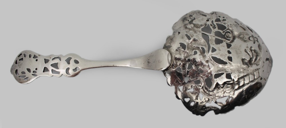 An antique Flemish silver spoon featuring an intricately pierced bowl decorated with a figurative orchard scene and a scrolling openwork handle. View VII