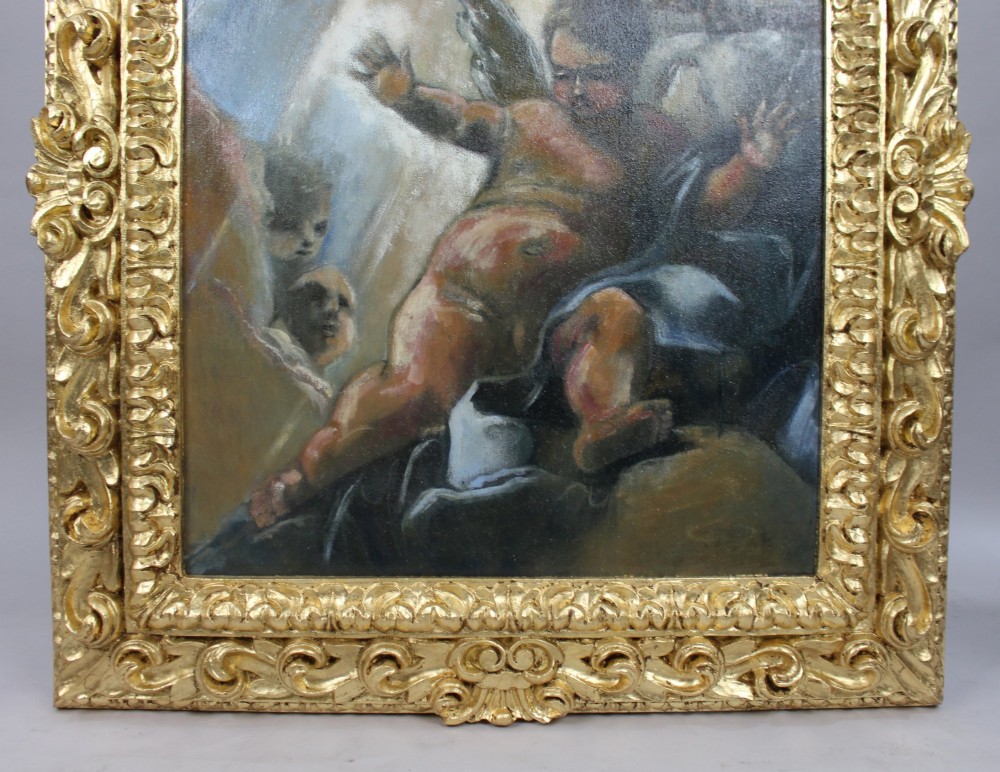 An Italian Renaissance style oil painting depicting cherub figures illuminated by light, housed inside a deeply carved gilded wood frame. View V
