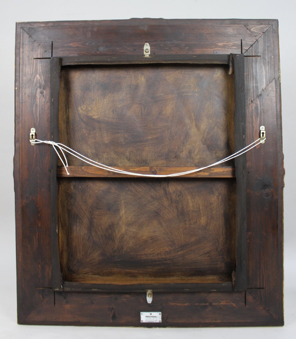 An Italian Renaissance style oil painting depicting cherub figures illuminated by light, housed inside a deeply carved gilded wood frame. View VI