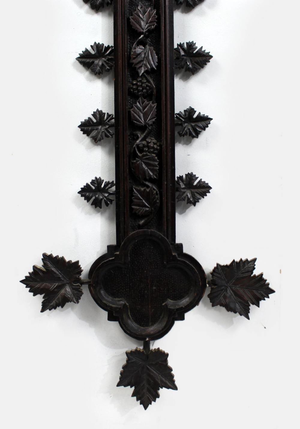 A 19th-century dark carved wood cross adorned with detailed foliate motifs and a gilt INRI inscription at the upper section. View IX