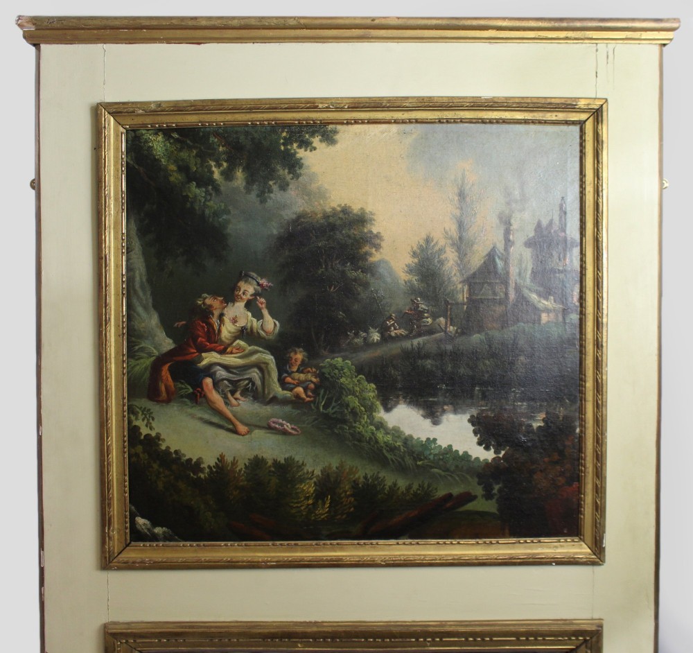 A tall French trumeau mirror featuring a cream painted wooden frame with gold beaded mouldings, an upper oil painting depicting a pastoral scene, and a rectangular mirror in the lower section. View II