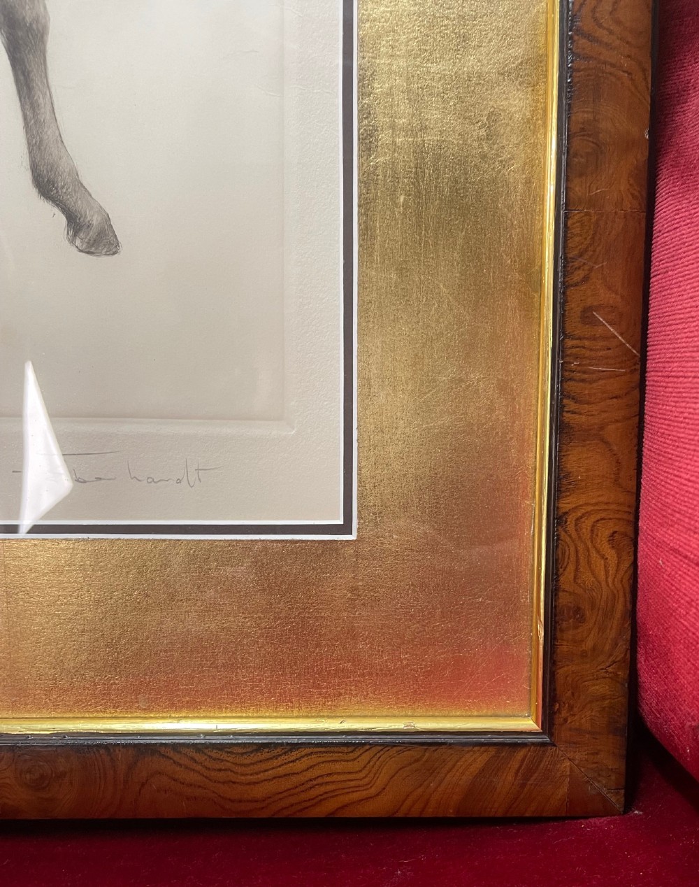 A framed monochrome drypoint etching of a standing foal, set within a gilded inner mount and a rich wood veneer frame. View V
