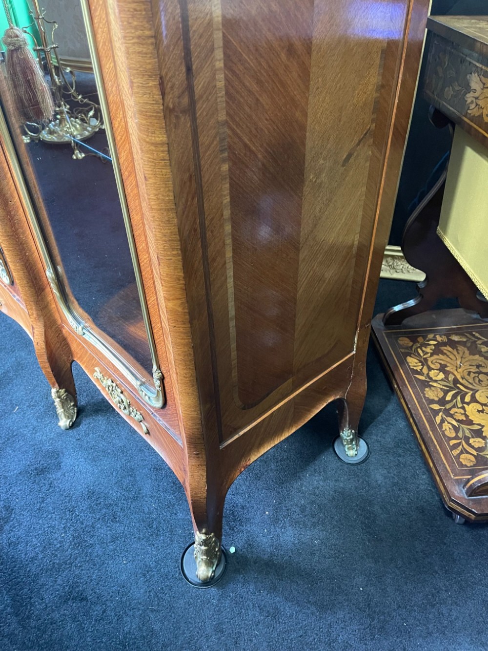 A large French kingwood display cabinet featuring three glass doors, gilded bronze mounts, and cabriole legs. View XIV