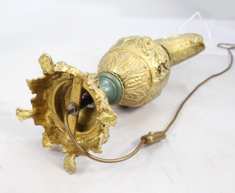 A pair of late nineteenth-century gilt metal table lamps fashioned in the shape of classical ewers with relief carving and green painted accents. View VIII