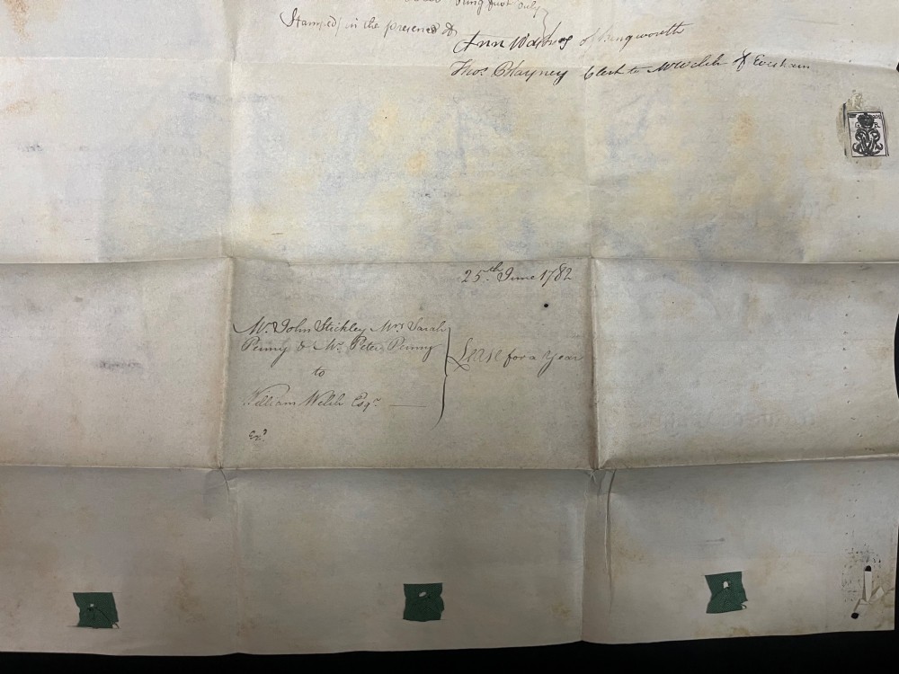 An 1782 handwritten George III vellum tripartite legal indenture featuring ornate calligraphy, a blue revenue stamp, and three red wax seals along the bottom edge. View VII