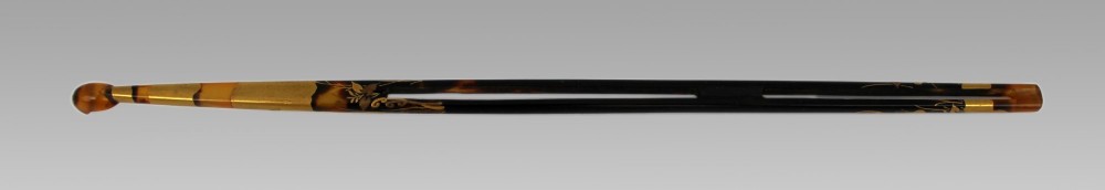 A two-piece Japanese hair ornament set comprising a crescent comb and a slender pin, crafted from mottled amber tortoiseshell with gold lacquer botanical motifs. View VIII
