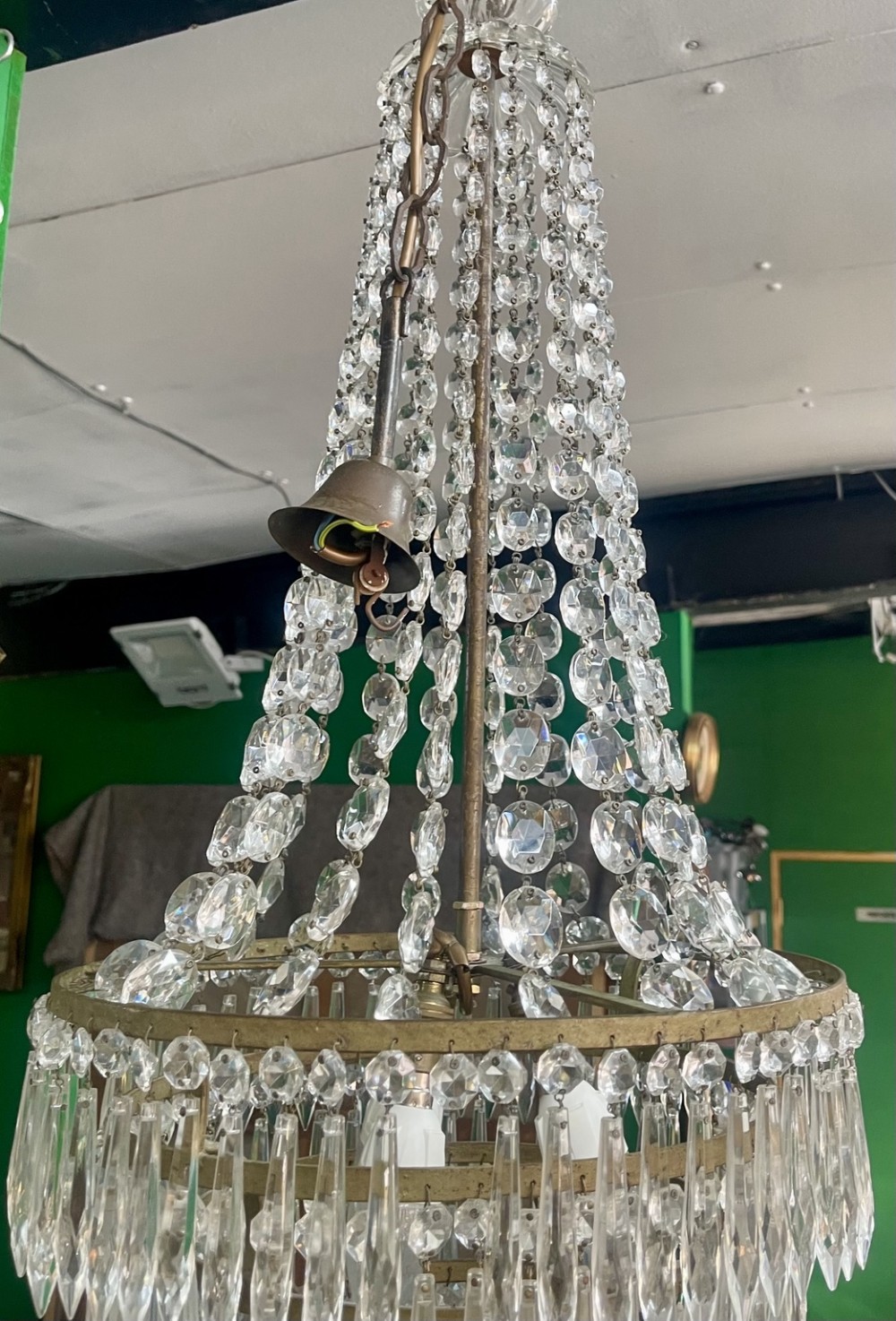 A French Empire style crystal waterfall chandelier with upper octagonal bead strands and lower cascading glass prisms attached to a brass band. View III