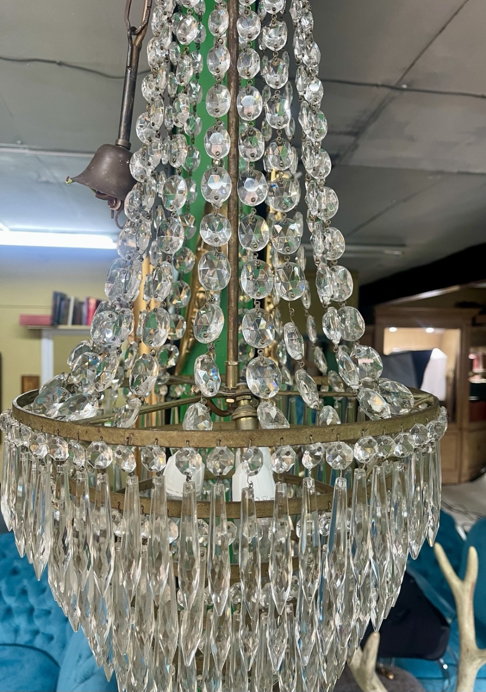 A French Empire style crystal waterfall chandelier with upper octagonal bead strands and lower cascading glass prisms attached to a brass band. View IV