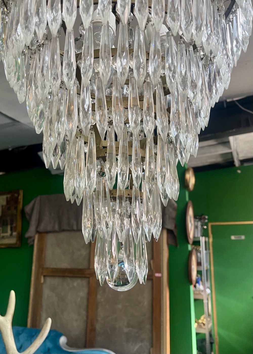 A French Empire style crystal waterfall chandelier with upper octagonal bead strands and lower cascading glass prisms attached to a brass band. View VII