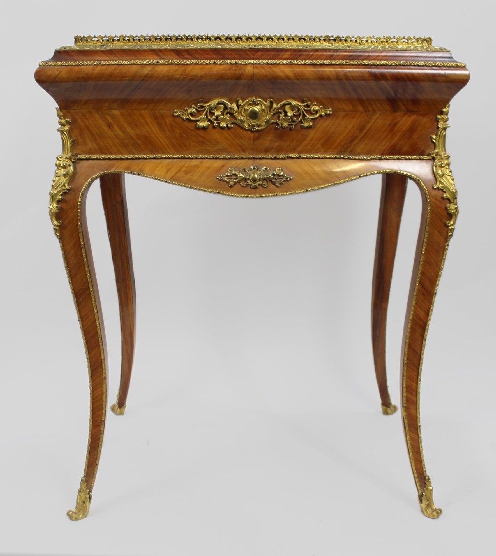 A 19th-century French kingwood jardiniere table featuring geometric parquetry inlay, ornate gilt-bronze mounts, cabriole legs, and a central floral porcelain plaque. View V