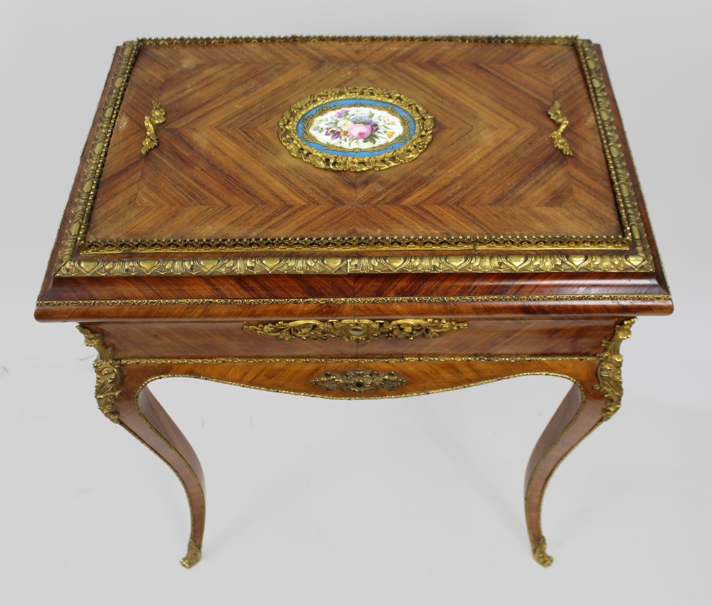 A 19th-century French kingwood jardiniere table featuring geometric parquetry inlay, ornate gilt-bronze mounts, cabriole legs, and a central floral porcelain plaque. View VI