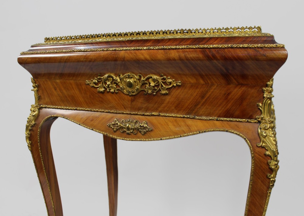 A 19th-century French kingwood jardiniere table featuring geometric parquetry inlay, ornate gilt-bronze mounts, cabriole legs, and a central floral porcelain plaque. View VII