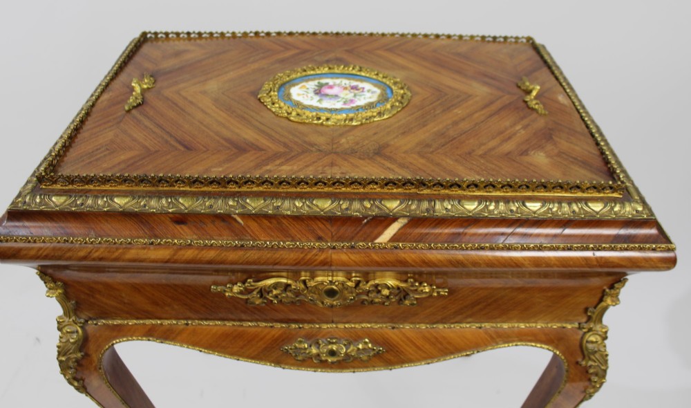 A 19th-century French kingwood jardiniere table featuring geometric parquetry inlay, ornate gilt-bronze mounts, cabriole legs, and a central floral porcelain plaque. View XII