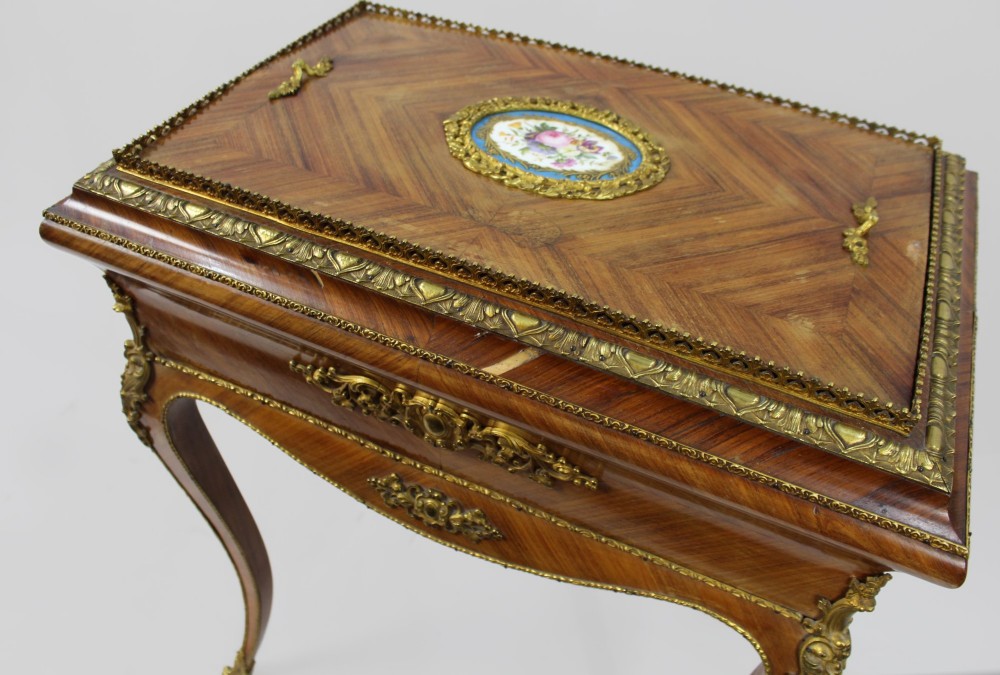 A 19th-century French kingwood jardiniere table featuring geometric parquetry inlay, ornate gilt-bronze mounts, cabriole legs, and a central floral porcelain plaque. View XIII