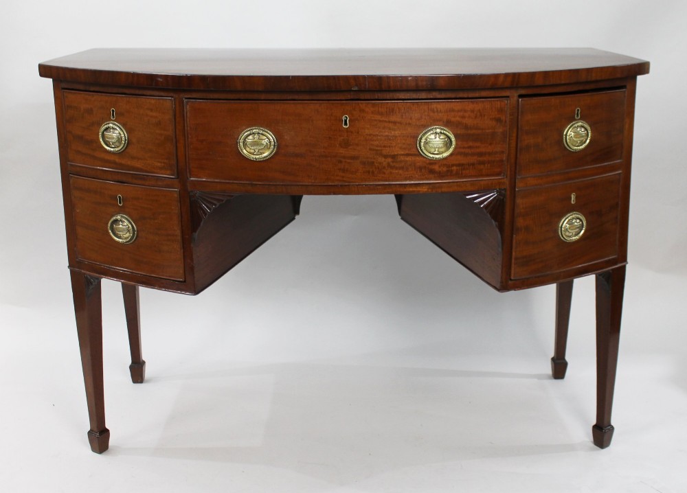 A George III bow-fronted mahogany serving table with brass oval handles, stringing inlay, and square tapered legs. View II