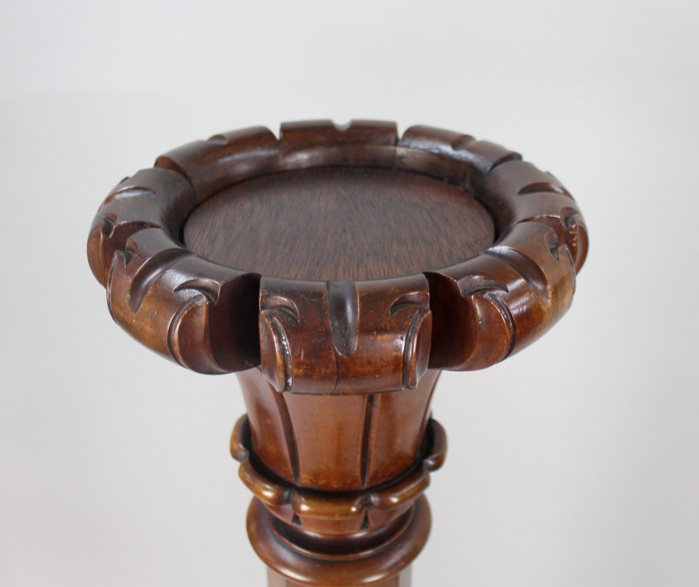 A pair of tall early Victorian carved mahogany pedestals featuring faceted stems, fluted top capitals, and detailed bulbous carved bases. View III