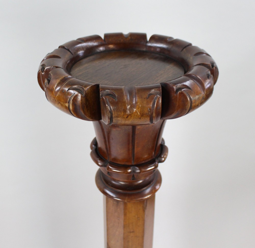 A pair of tall early Victorian carved mahogany pedestals featuring faceted stems, fluted top capitals, and detailed bulbous carved bases. View VI