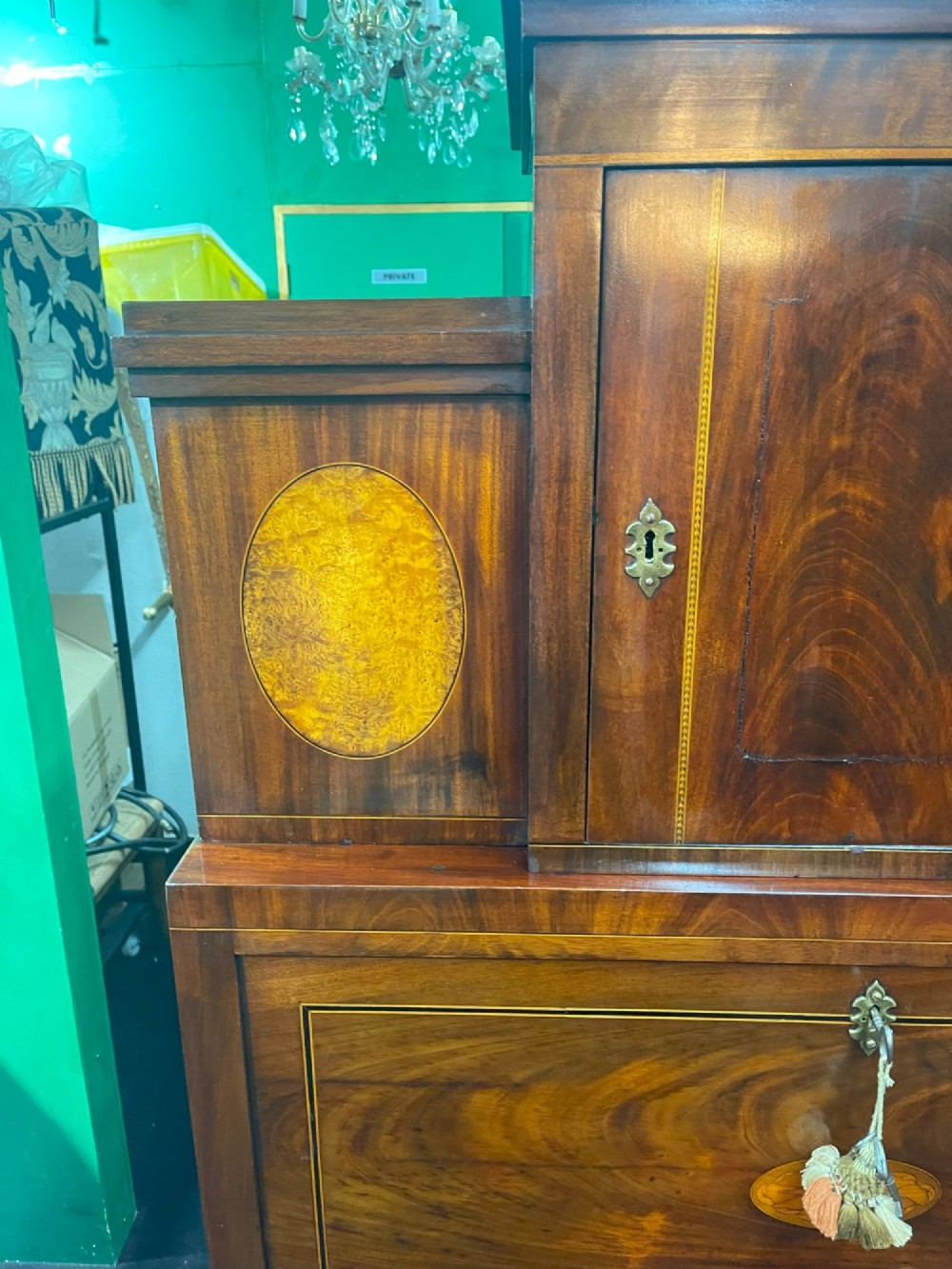 A tall Georgian mahogany secretaire chest featuring stepped upper cabinets with oval satinwood inlay, a pull-out writing drawer, and three lower drawers with brass handles. View VIII