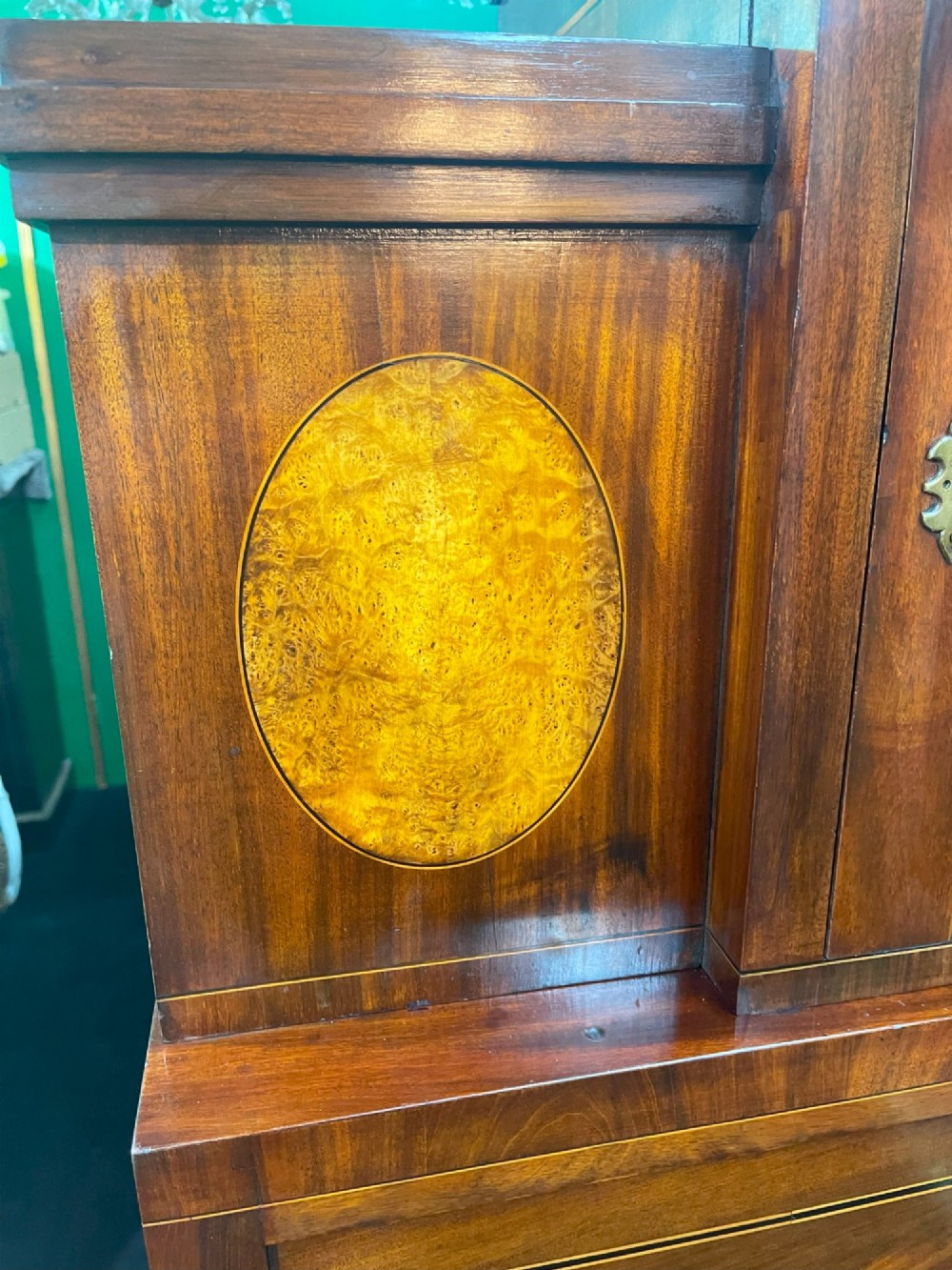 A tall Georgian mahogany secretaire chest featuring stepped upper cabinets with oval satinwood inlay, a pull-out writing drawer, and three lower drawers with brass handles. View IX